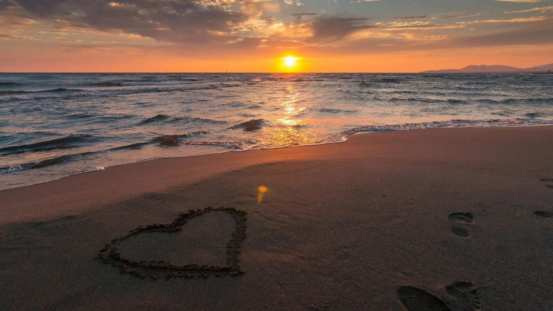 seaside view with love heart in sand